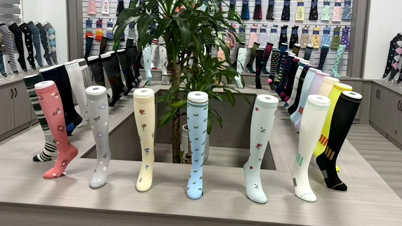 Compression sock samples displayed in a factory sample room for quality review